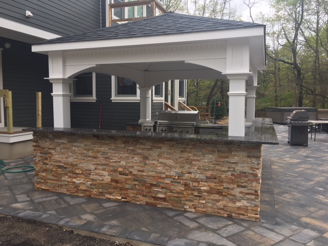 Covered Outdoor Kitchen by Millenium Stoneworks