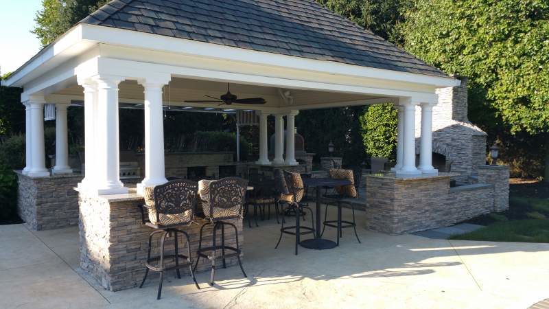 Custom Outdoor Kitchen with Seating and Fireplace