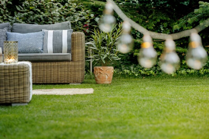 Luxury outdoor living space with custom paver patio, outdoor kitchen, and fireplace extension