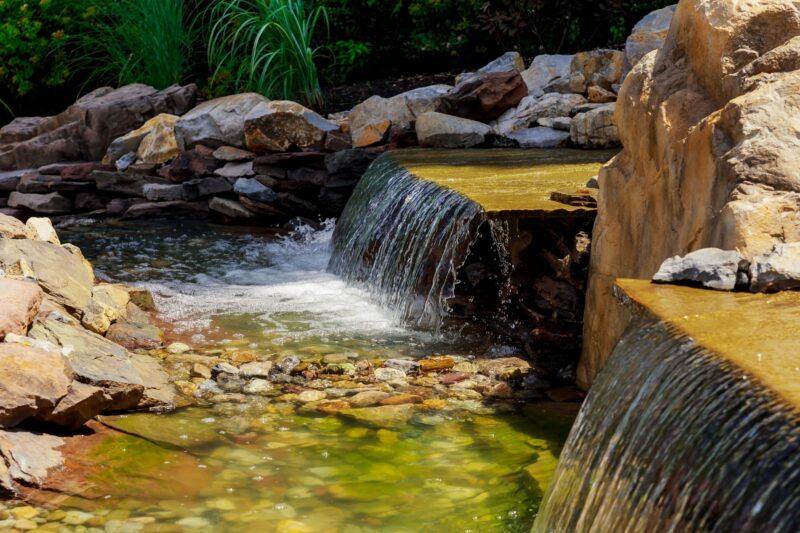 Modern hardscape design with integrated backyard water feature