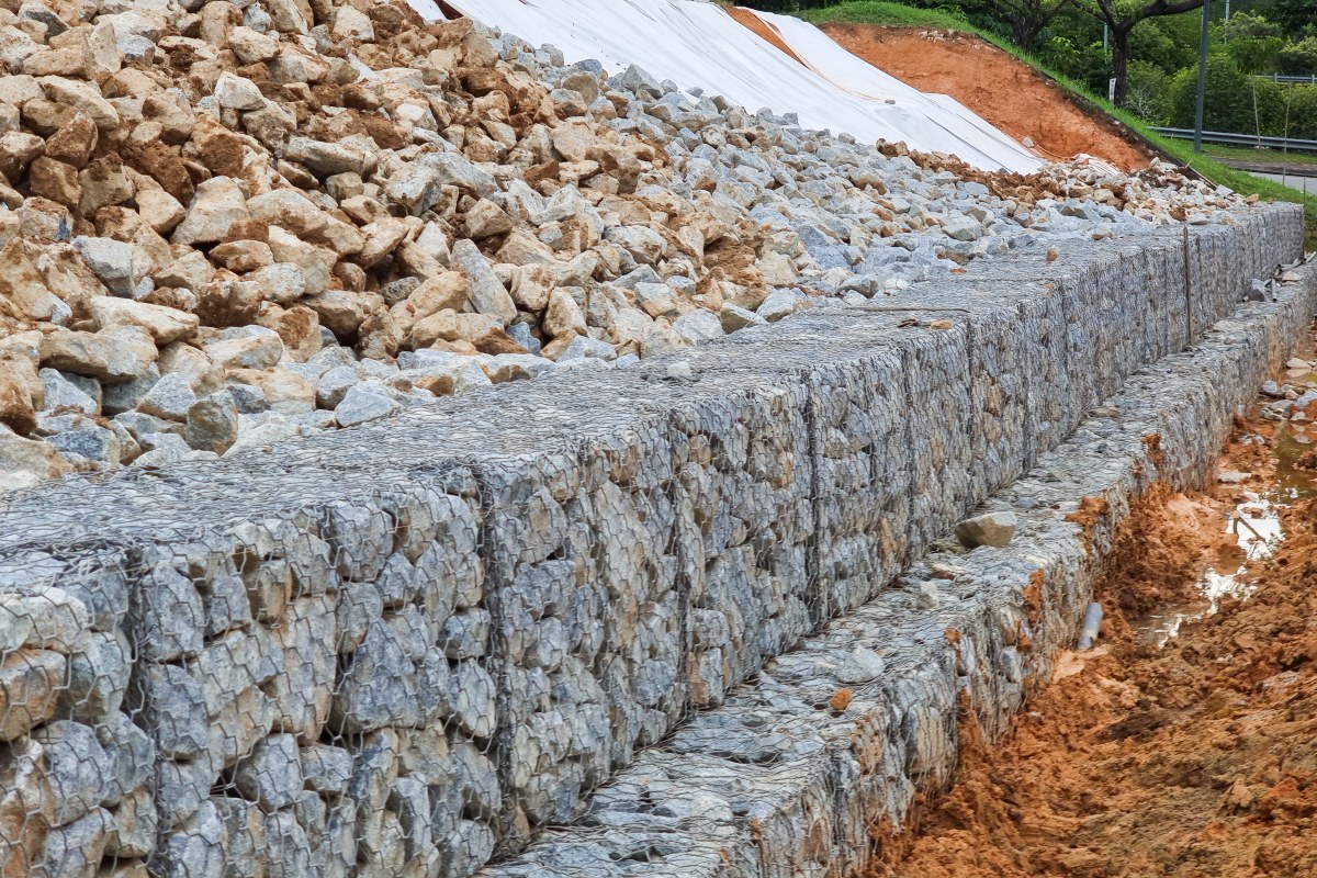 Custom natural stone retaining wall installation by Millenium Stoneworks in New Jersey